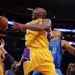Los Angeles Lakers' Kobe Bryant, center, shoots against Dallas Mavericks' Shawn Marion (0) as Elton Brand (42) and Lakers' Pau Gasol (16) watch in the first half of an NBA basketball game in Los Angeles, Tuesday, Oct. 30, 2012. (AP Photo/Jae C. Hong