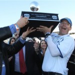  UCLA head football coach Jim Mora, right, and athletic director Dan Guerrero held up the Sun Bowl championship trophy after defeating Virginia Tech 42-12 in an NCAA college football game Tuesday Dec. 31, 2013, in El Paso, Texas. (AP Photo/Victor Calzada)