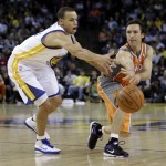 Phoenix Suns' Steve Nash, right, passes away from Golden State Warriors' Stephen Curry during the second half of an NBA basketball game Thursday, Dec. 2, 2010, in Oakland, Calif. (AP Photo/Ben Margot)