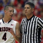 Arizona's T.J. McConnell (4) talks to Official Mike Reed, right, during a foul shot in the second half against California in an NCAA college basketball game on Wednesday, Feb. 26, 2014 in Tucson, Ariz. Arizona won 87 - 59. (AP Photo/John MIller)