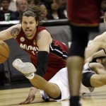Miami Heat shooting guard Mike Miller, San Antonio Spurs point guard Cory Joseph and Matt Bonner, right, battle for a loose ball during the first half at Game 3 of the NBA Finals basketball series, Tuesday, June 11, 2013, in San Antonio. (AP Photo/Eric Gay)