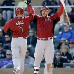 Arizona Diamondbacks' Eric Hinske, right, greets Cody Ross (7) at the plate after Ross scored on a triple from Eric Chavez during the fifth inning of an exhibition spring training baseball game against the Colorado Rockies, Sunday, Feb. 24, 2013, in Scottsdale, Ariz. (AP Photo/Marcio Jose Sanchez)