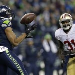  Seattle Seahawks' Doug Baldwin catches a pass in front of San Francisco 49ers' Donte Whitner (31) during the first half of the NFL football NFC Championship game, Sunday, Jan. 19, 2014, in Seattle. (AP Photo/Marcio Jose Sanchez)