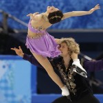 Meryl Davis and Charlie White of the United States compete in the ice dance free dance figure skating finals at the Iceberg Skating Palace during the 2014 Winter Olympics, Monday, Feb. 17, 2014, in Sochi, Russia. The couple would go on to win the United States' first-ever gold medal in the event. (AP Photo/Vadim Ghirda)