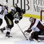 Colorado Avalanche goalie Jean-Sebastien Giguere (35) stops a shot by Pittsburgh Penguins' Evgeni Malkin (71) with help from Jan Hejda (8) in the third period of an NHL hockey game in Pittsburgh Monday, Oct. 21, 2013. The Avalanche won 1-0. (AP Photo/Gene J. Puskar