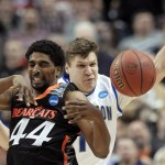 Cincinnati's JaQuon Parker, left, and Creighton's Grant Gibbs collide during the first half of a second-round game of the NCAA college basketball tournament, Friday, March 22, 2013, in Philadelphia. (AP Photo/Michael Perez)
