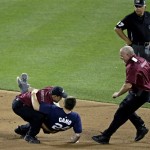 A security guard tackles a fan that ran on the field during the MLB All-Star baseball game, on Tuesday, July 16, 2013, in New York. (AP Photo/Frank Franklin II)