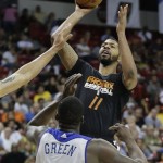 Phoenix Suns' Markieff Morris (11) puts up a shot against Golden State Warriors' Draymond Green (23) in the fourth quarter of the NBA Summer League championship game, Monday, July 22, 2013, in Las Vegas.The Warriors won 91-77. (AP Photo/Julie Jacobson)
