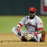 Cincinnati Reds second baseman Brandon Phillips (4) sits on the ground after making an error in the fifth inning during a baseball game against the Arizona Diamondbacks on Sunday, June 23, 2013, in Phoenix. (AP Photo/Rick Scuteri)