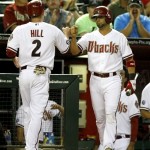 Arizona Diamondbacks second baseman Aaron Hill (2) celebrates with Wil Nieves (27) after scoring in the seventh inning during a baseball game against the Baltimore Orioles on Tuesday, Aug. 13, 2013, in Phoenix. (AP Photo/Rick Scuteri)