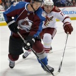  Colorado Avalanche defenseman Nick Holden (2) and Phoenix Coyotes right wing Radim Vrbata (17) chase the puck into the corner during the second period of an NHL hockey game on Friday, Feb. 28, 2014, in Denver. (AP Photo/Jack Dempsey)
