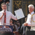 San Francisco Mayor Gavin Newsom, left, reads a proclamation as San Francisco Giants owner Bill Neukom, right, looks on during the Giants' World Series victory celebration at Civic Center Plaza in San Francisco, Wednesday, Nov. 3, 2010.(AP Photo/Noah Berger)