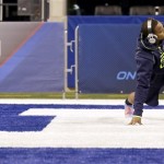 Michigan wide receiver Jeremy Gallon stretches on the field at the NFL football scouting combine in Indianapolis, Sunday, Feb. 23, 2014. (AP Photo/Nam Y. Huh)