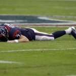 Houston Texans quarterback Case Keenum lays on the ground after being sacked by Oakland Raiders' Lamarr Houston during the first half of an NFL football game Sunday, Nov. 17, 2013, in Houston. (AP Photo/Patric Schneider)