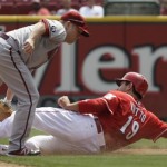  Arizona Diamondbacks second baseman Aaron Hill tags out Cincinnati Reds' Joey Votto (19) trying to steal second base in the fifth inning of a baseball game, Thursday, Aug. 22, 2013, in Cincinnati. (AP Photo/Al Behrman)