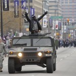 Baltimore Ravens safety Ed Reed greets fans while riding in a Humvee during the Ravens victory parade Tuesday, Feb. 5, 2013, in Baltimore. The Ravens defeated the San Francisco 49ers in NFL football's Super Bowl XLVII 34-31 on Sunday. (AP Photo/Gail Burton)