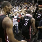 Miami Heat's Chris Bosh (1), Dwyane Wade (3), and LeBron James (6) leave the floor after defeating San Antonio Spurs at Game 4 of the NBA Finals basketball series, Thursday, June 13, 2013, in San Antonio. The Heat won 109-93. (AP Photo/Eric Gay)