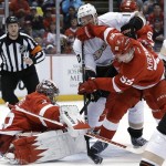 Detroit Red Wings defenseman Niklas Kronwall (55), of Sweden, clears the puck from Anaheim Ducks right wing Corey Perry (10) in front of Red Wings goalie Jimmy Howard during the first period in Game 2 of a first-round NHL hockey Stanley Cup playoff series in Detroit, Saturday, May 4, 2013. (AP Photo/Paul Sancya)