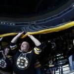 Boston Bruins fans pass a large banner through the stands before Game 3 of the NHL hockey Stanley Cup Finals against the Chicago Blackhawks in Boston, Monday, June 17, 2013. (AP Photo/Elise Amendola)