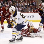  Buffalo Sabres' Tyler Ennis (63) scores a goal as he gets the puck past a diving Phoenix Coyotes' Thomas Greiss, of Germany, center, as Coyotes' Oliver Ekman-Larsson (23), of Sweden, and Zbynek Michalek, of the Czech Republic, and Sabres' Matt Moulson (26) and Zemgus Girgensons (28), of Latvia, look on during the first period of an NHL hockey game on Thursday, Jan. 30, 2014, in Glendale, Ariz. (AP Photo)