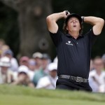 Phil Mickelson reacts after hitting out of a bunker on the second hole during the fourth round of the U.S. Open golf tournament at Merion Golf Club, Sunday, June 16, 2013, in Ardmore, Pa. (AP Photo/Darron Cummings)