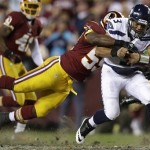 Seattle Seahawks quarterback Russell Wilson is stopped by Washington Redskins inside linebacker London Fletcher during the first half of an NFL wild card playoff football game in Landover, Md., Sunday, Jan. 6, 2013. (AP Photo/Evan Vucci)