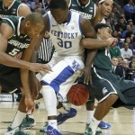 Michigan State center Adreian Payne (5), Kentucky forward Julius Randle (30) and Michigan State guard Gary Harris, right, struggle for a loose ball during the first half of an NCAA college basketball game Tuesday, Nov. 12, 2013, in Chicago. (AP Photo/Charles Rex Arbogast)