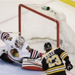 Boston Bruins center Chris Kelly (23) scores past Chicago Blackhawks goalie Corey Crawford (50)during the first period in Game 6 of the NHL hockey Stanley Cup Finals, Monday, June 24, 2013, in Boston. (AP Photo/Charles Krupa)