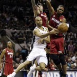 San Antonio Spurs point guard Tony Parker (9) passes the ball around Miami Heat forward Chris Andersen and center Chris Bosh (1) during the first half at Game 3 of the NBA Finals basketball series, Tuesday, June 11, 2013, in San Antonio. (AP Photo/Eric Gay)
