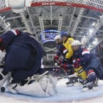 Anna Borgqvist of Sweden's goal rolls underneath USA Goalkeeper Jessie Vetter as Lee Stecklein (2) and Josephine Pucci of the United States (24) box in Fanny Rask of Sweden during the third period of the 2014 Winter Olympics women's semifinal ice hockey game at Shayba Arena, Monday, Feb. 17, 2014, in Sochi, Russia. USA defeated Sweden 6-1. (AP Photo/Bruce Bennett, Pool)