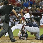 Atlanta Braves' Brian McCann, right, tags out Arizona Diamondbacks' Martin Prado trying to score as umpire Jim Reynolds moves in to make the call during the fourth inning of a baseball game, on Monday, May 13, 2013, in Phoenix. (AP Photo/Ross D. Franklin)