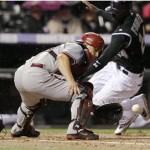 Arizona Diamondbacks catcher Miguel Montero, front, fields the throw 
from the outfield as Colorado Rockies' Dexter Fowler scores on a 
single by Michael Cuddyer in the third inning of a baseball game in 
Denver, Saturday, April 14, 2012. (AP Photo/David Zalubowski)