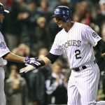 Colorado Rockies shortstop Troy Tulowitzki (2) is congratulated by teammate right fielder Michael Cuddyer after hitting a home run, for two runs, in the fourth inning of a baseball game against the Arizona Diamondbacks at Coors Field in Denver on Friday, April 19, 2013. (AP Photo/Brennan Linsley)