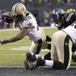 New Orleans Saints running back Khiry Robinson, left, runs for a 1-yard touchdown during the fourth quarter of an NFC divisional playoff NFL football game against the Seattle Seahawks in Seattle, Saturday, Jan. 11, 2014. (AP Photo/Elaine Thompson)