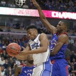 Duke forward Jabari Parker, left, grabs a rebound on a missed shot by Kansas guard Andrew Wiggins, right, during the second half of an NCAA college basketball game on Tuesday, Nov. 12, 2013, in Chicago. (AP Photo/Charles Rex Arbogast)