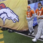 Denver Broncos quarterbacks Zac Dysert (2) and Brock Osweiler (17) walk onto the field at MetLife Stadium for the team's walk-through on Saturday, Feb. 1, 2014, in East Rutherford, N.J. The Broncos are scheduled to play the Seattle Seahawks in the NFL Super Bowl XLVIII football game Sunday. (AP Photo/Mark Humphrey)