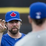 Toronto Blue Jays starting pitcher R.A. Dickey, left, talks with catcher Josh Thole, right, during baseball spring training in Dunedin, Fla., on Tuesday, Feb. 12, 2013. (AP Photo/The Canadian Press, Nathan Denette)