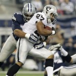 Oakland Raiders running back Rashad Jennings (27) is tackled by Dallas Cowboys defensive tackle Jason Hatcher (97) during the first half of an NFL football game, Thursday, Nov. 28, 2013, in Arlington, Texas. (AP Photo/LM Otero)
