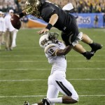 Baylor quarterback Bryce Petty leaps over Central Florida defensive back Jacoby Glenn (12) for a touchdown during the first half of the Fiesta Bowl NCAA college football game, Wednesday, Jan. 1, 2014, in Glendale, Ariz. (AP Photo/Ross D. Franklin)
