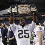 Pittsburgh defensive back Jason Hendricks (25) holds up a wrestling championship belt after the Panthers defeated Bowling Green 30-27 in the Little Caesars Pizza Bowl NCAA college football game, Thursday, Dec. 26, 2013, in Detroit. (AP Photo/Carlos Osorio)