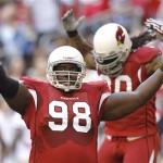 Arizona Cardinals' Nick Eason (98) and Darnell Dockett try to get the fans cheering loud during the first quarter in an NFL football game against the San Francisco 49ers, Sunday, Dec. 11, 2011, Glendale, Ariz.(AP Photo/Ross D. Franklin)