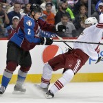  Colorado Avalanche defenseman Nick Holden (2) knocks Phoenix Coyotes center Martin Hanzal (11) off his skates during the second period of an NHL hockey game on Friday, Feb. 28, 2014, in Denver. (AP Photo/Jack Dempsey)