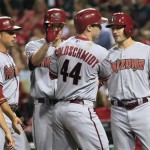 Arizona Diamondbacks Paul Goldschmidt gets contratulated by teammates Martin Prado, Patrick Corbin, and A.J. Plollock, left to right, after hitting a grand slam against the Cincinnati Reds in the eighth inning of their baseball game in Cincinnati Tuesday, Aug. 20, 2013. (AP Photo/Tom Uhlman)on

