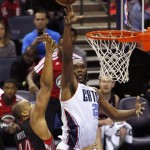 Charlotte Bobcats center Al Jefferson, right, shoots over Toronto Raptors forward Chuck Hayes in the second half of an NBA basketball game, Monday, Jan. 20, 2014, in Charlotte, N.C. Charlotte won 100-95. (AP Photo/Nell Redmond)