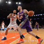 Phoenix Suns' Marcin Gortat, right, drives on New York Knicks' Tyson Chandler in the fourth quarter of an NBA basketball game at Madison Square Garden in New York, Sunday, Dec. 2, 2012. Gortat was the Suns' high-scorer with 18 points in the Knicks' 106-99 win. (AP Photo/Henny Ray Abrams)