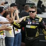 Carl Edwards high-fives fans during driver introductions before the NASCAR Sprint Cup Series auto race, Sunday, March 3, 2013, in Avondale, Ariz. (AP Photo/Ross D. Franklin)