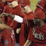 Arizona Diamondbacks' Didi Gregorius, right, laughs as he throws dirt on the head of teammate Willie Bloomquist, left, after Bloomquist delivered the game-winning walkoff hit in the 10th inning of a baseball game against the Toronto Blue Jays,Wednesday, Sept. 4, 2013, in Phoenix. The Diamondbacks defeated the Blue Jays 4-3. (AP Photo/Ross D. Franklin)