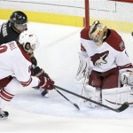  Phoenix Coyotes goalie Thomas Greiss, right, blocks a shot by Anaheim Ducks right wing Teemu Selanne, top left, with the help of Gilbert Brule during the first period of an NHL hockey game in Anaheim, Calif., Saturday, Dec. 28, 2013. (AP Photo/Chris Carlson)