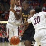 Long Beach State's Christian Griggs-Williams, middle, tries to dribble between Arizona's Gabe York, left, and Jordin Mayes (20) in the first half of an NCAA college basketball game, Monday, Nov. 11, 2013 in Tucson, Ariz. (AP Photo/Wily Low)