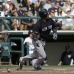 New York Yankees' Robinson Cano, right, watches his home run during an exhibition spring training baseball game against the Atlanta Braves Saturday, Feb. 23, 2013, in Kissimmee, Fla. (AP Photo/David J. Phillip)
